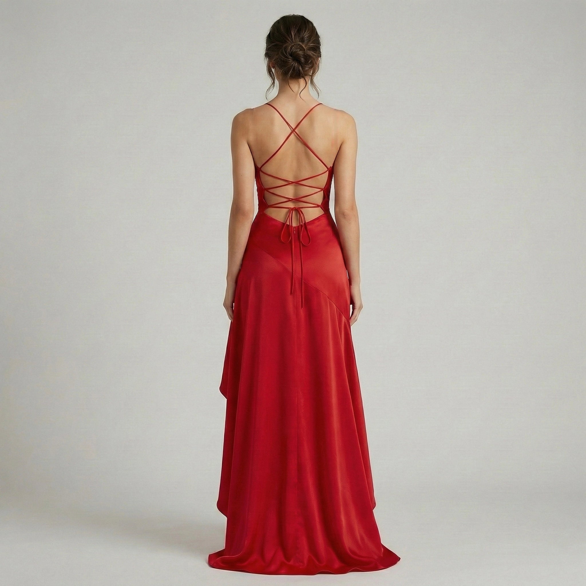 Red evening gown with a strappy back on a plain background