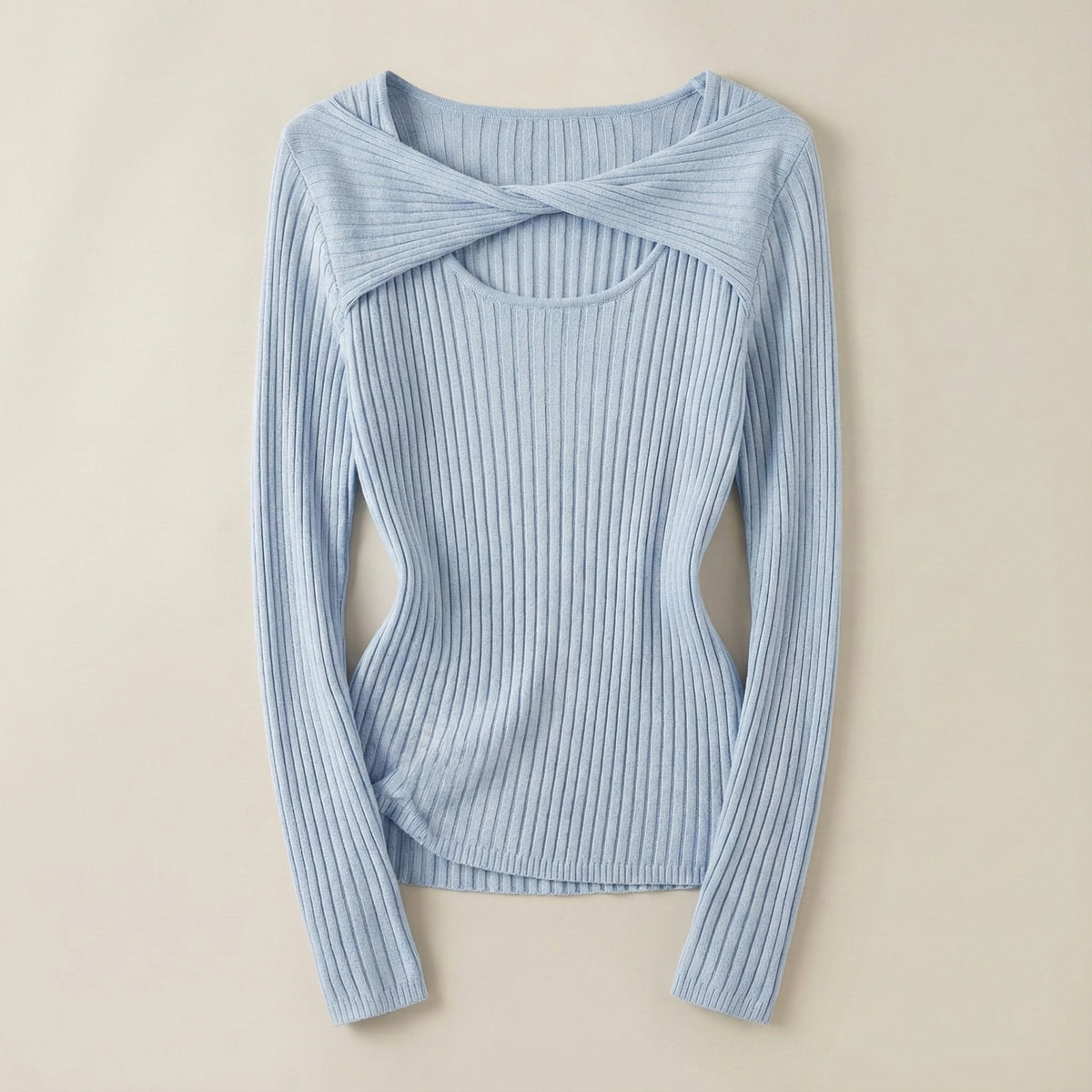 Light blue ribbed sweater with a knot detail on a beige background