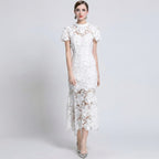 Woman wearing a white lace dress on a gray background