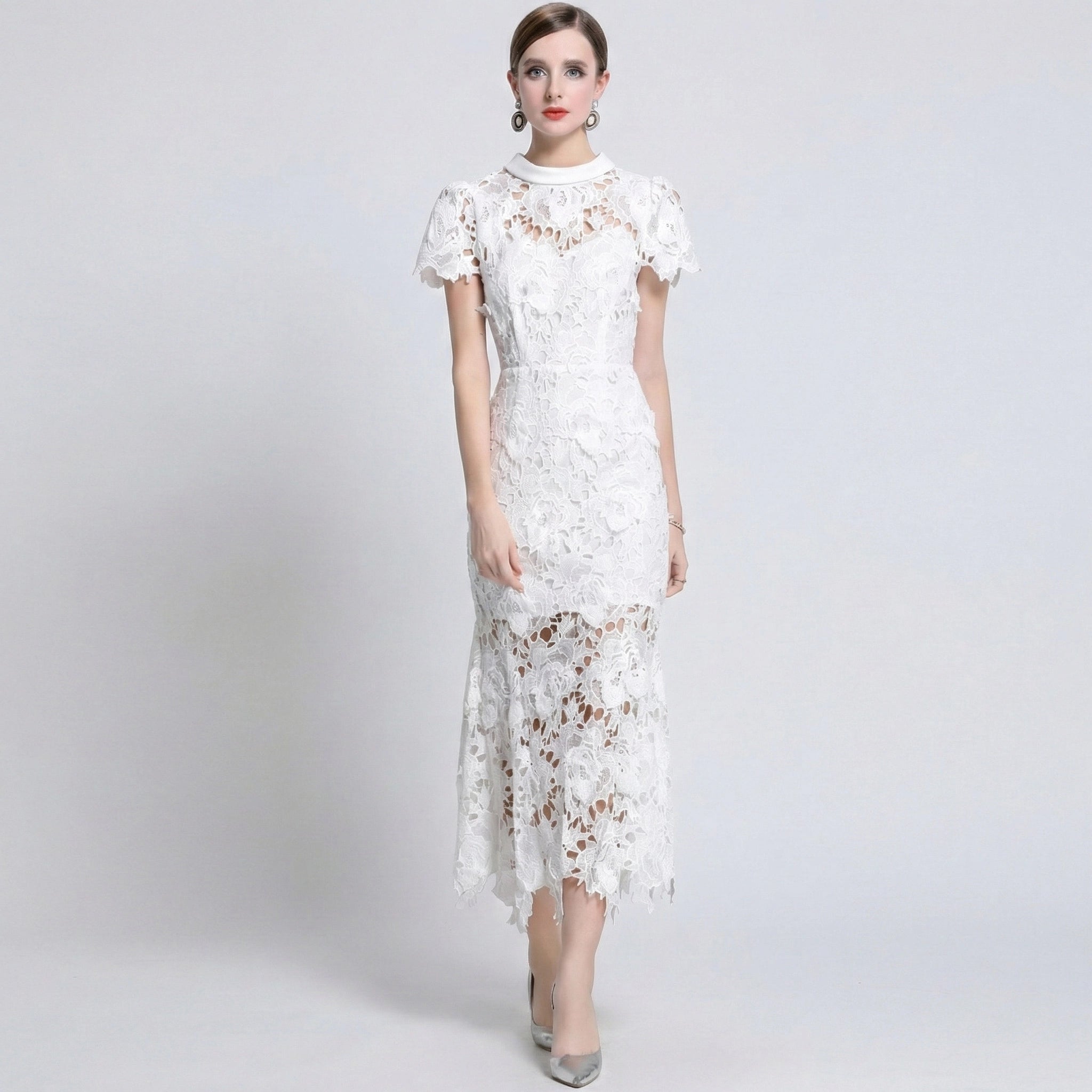 Woman wearing a white lace dress on a gray background