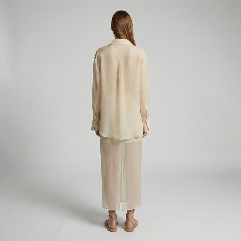 Woman wearing a beige outfit on a plain background