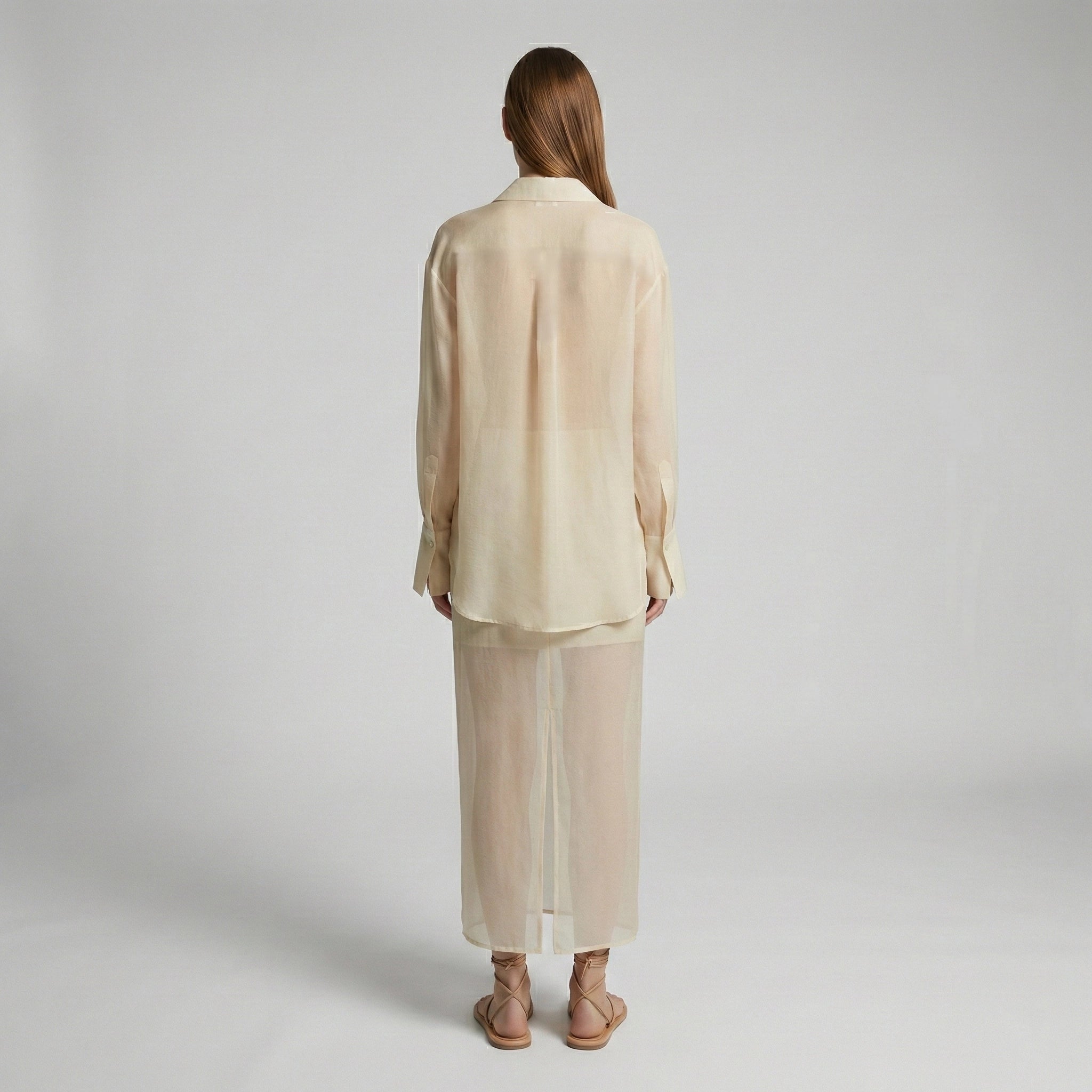 Woman wearing a beige outfit on a plain background