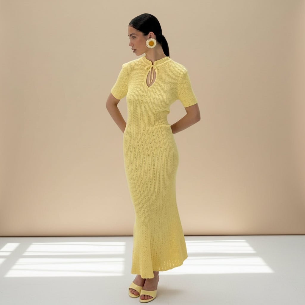 Woman wearing a yellow dress against a gray background