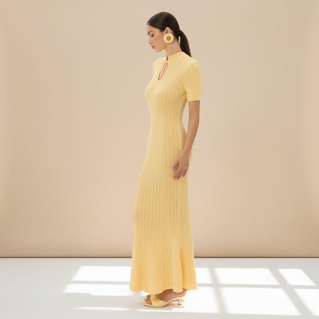 Woman wearing a yellow dress on a gray background