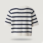 Striped sweater with navy and white colors on a light gray background