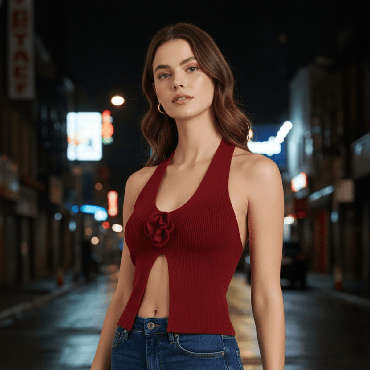 Woman wearing a red halter top with a blurred city street background