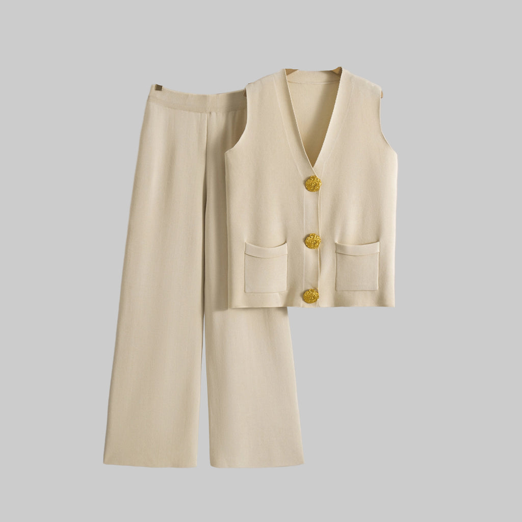 Beige vest and wide-leg pants on hangers against a gray background