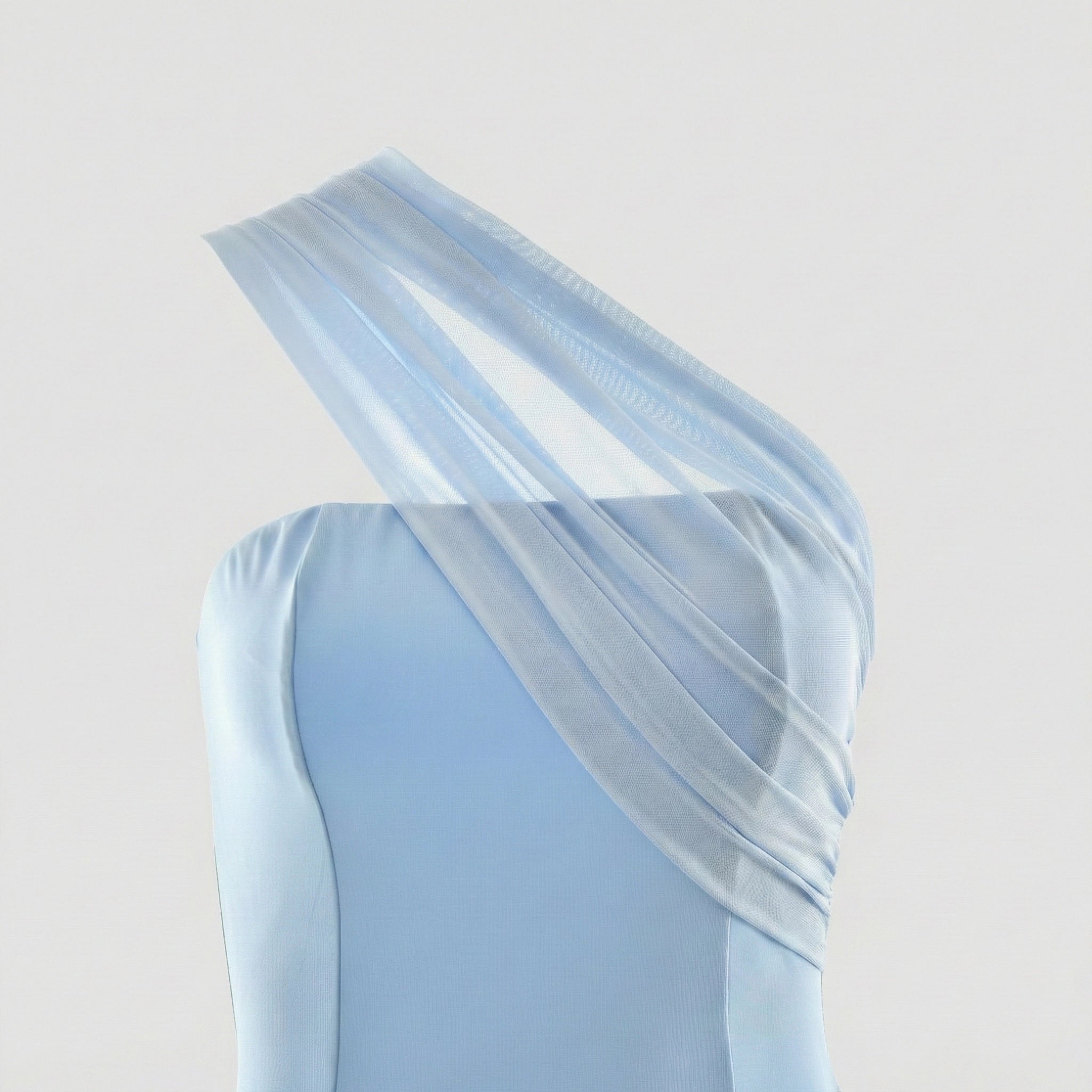 Light blue one-shoulder dress with sheer overlay on a light gray background