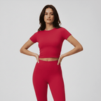 Woman wearing a red athletic outfit on a gray background