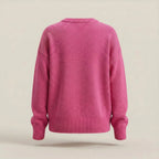 Pink sweater on a beige background
