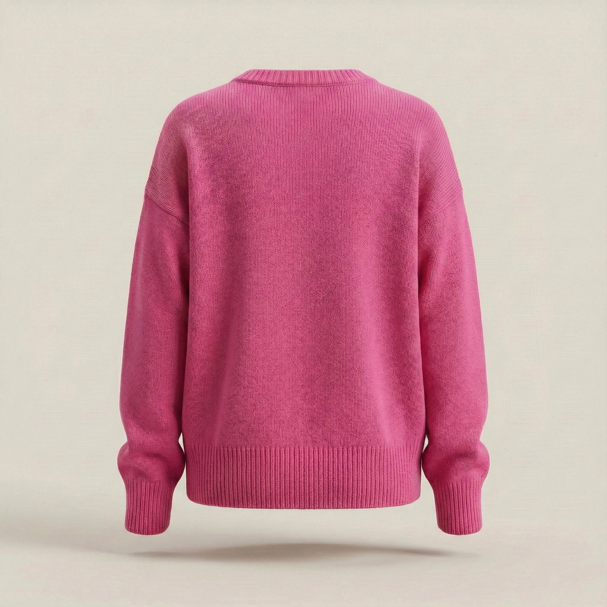Pink sweater on a beige background