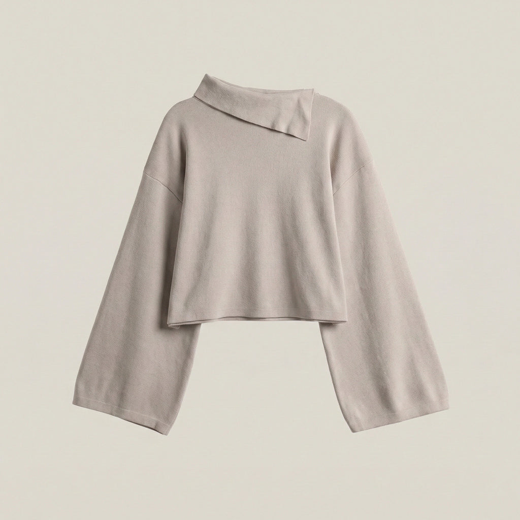 Light gray long-sleeve top on a beige background