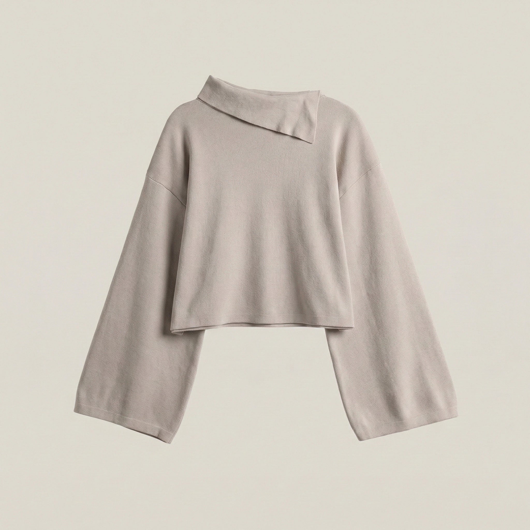 Light gray long-sleeve top on a beige background