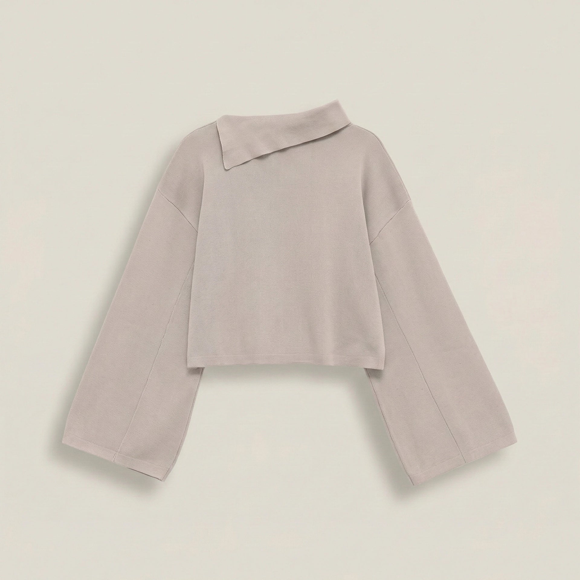 Light purple sweater on a light beige background