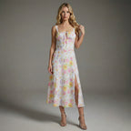 Woman wearing a floral dress against a gray background