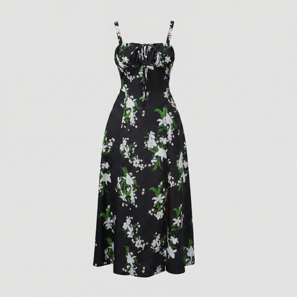 Black floral dress with white flowers and green leaves on a light gray background