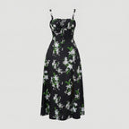 Black floral dress with white flowers and green leaves on a light gray background