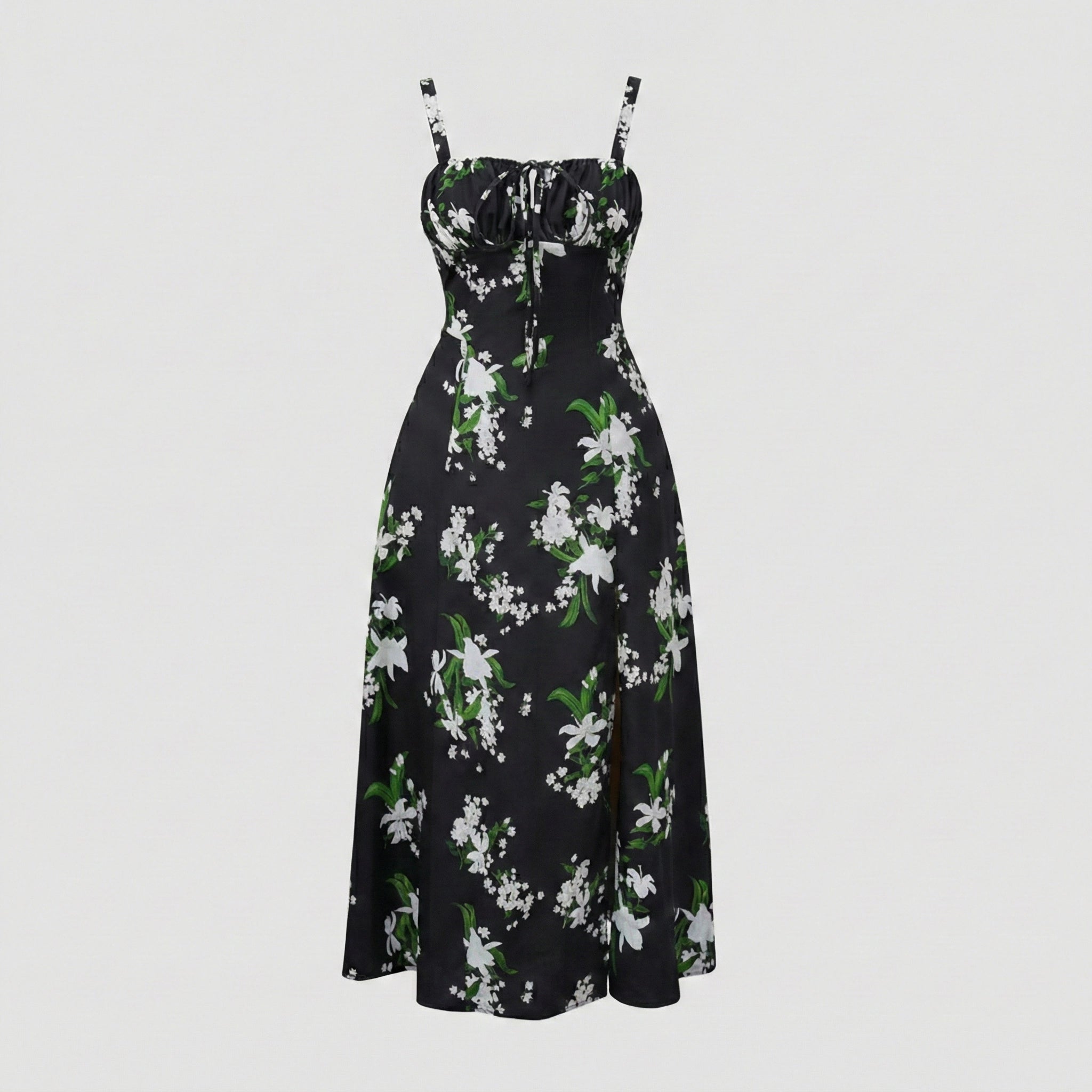 Black floral dress with white flowers and green leaves on a light gray background