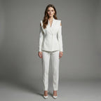 Woman wearing a white suit against a gray background