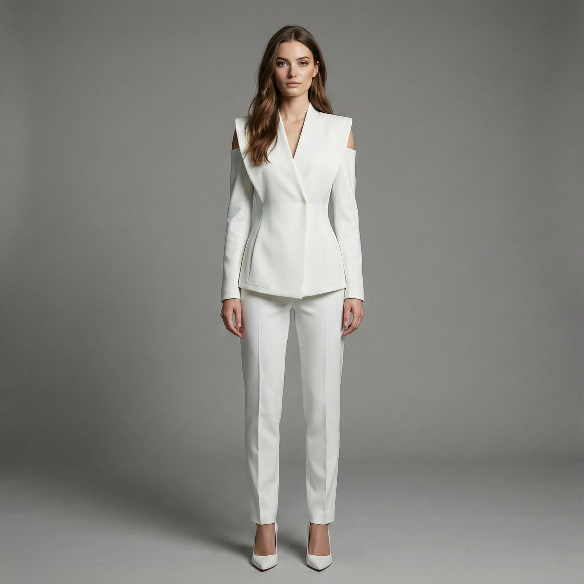 Woman wearing a white suit against a gray background