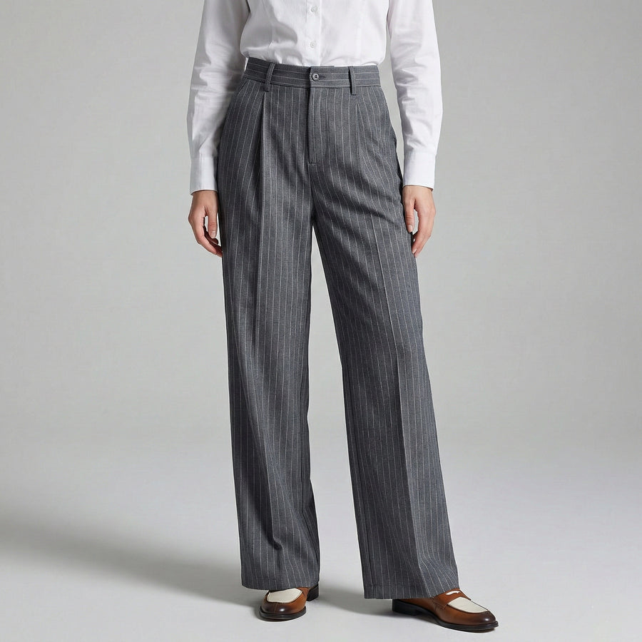 Person wearing gray pinstripe pants and a white shirt on a light gray background