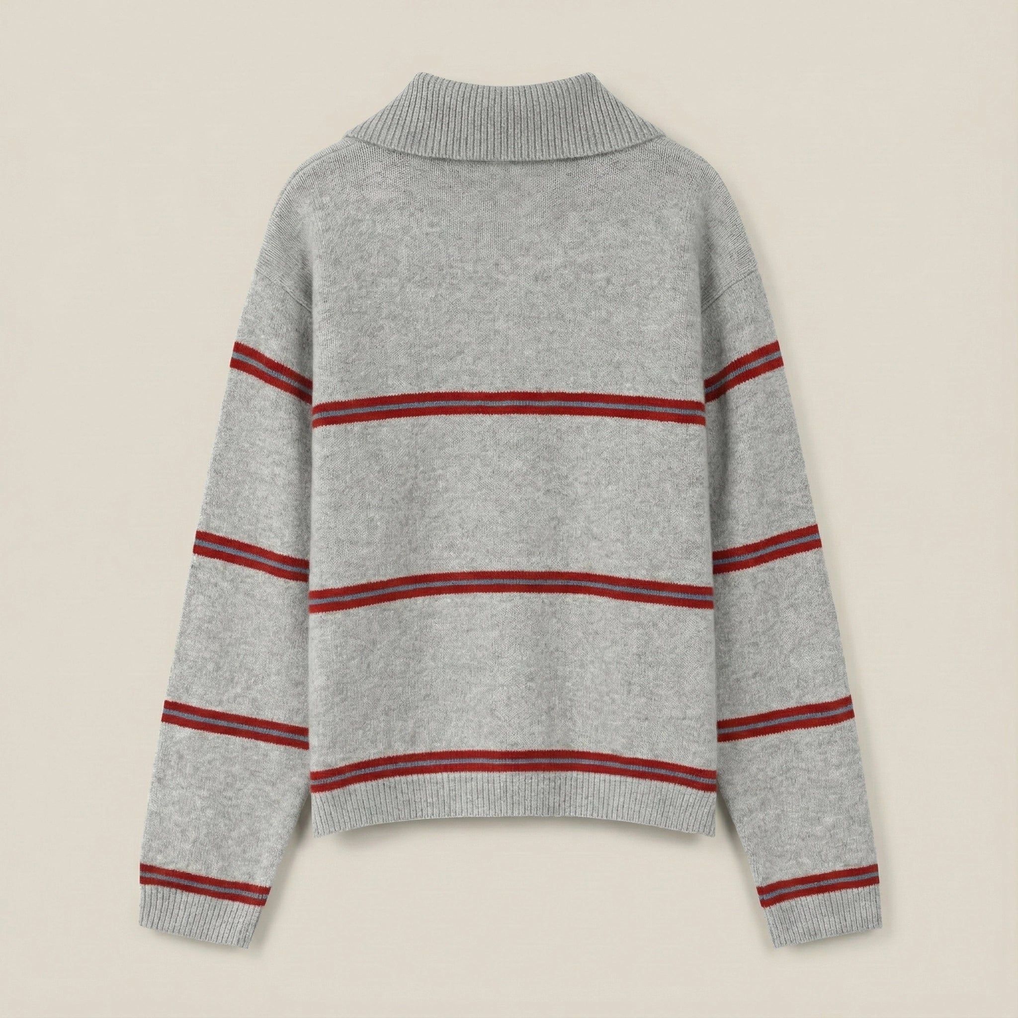 Gray sweater with red stripes on a beige background