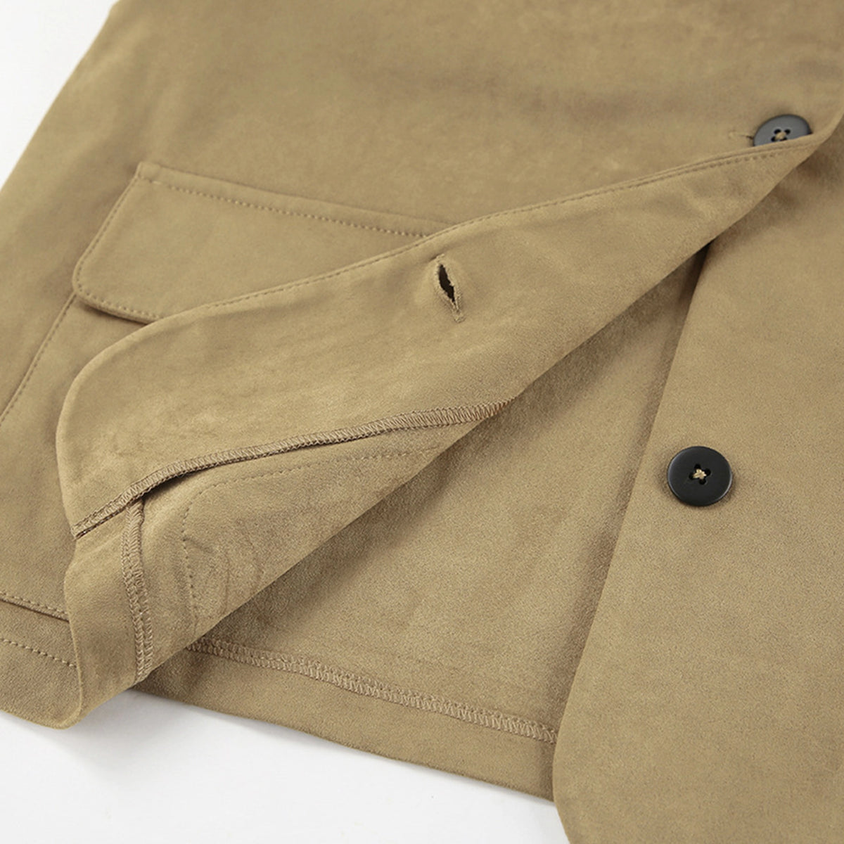 Close-up of a beige jacket with a button and pocket detail on a white background