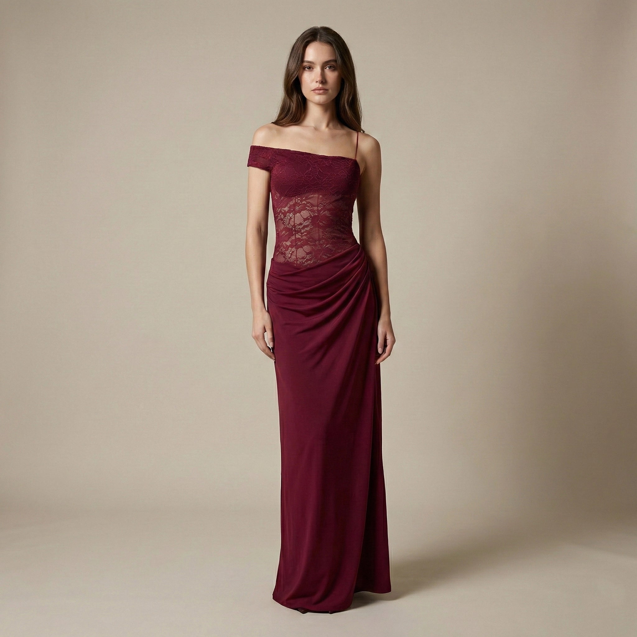 Woman wearing a burgundy off-shoulder gown against a beige background
