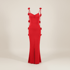 Red evening gown with decorative straps on a beige background