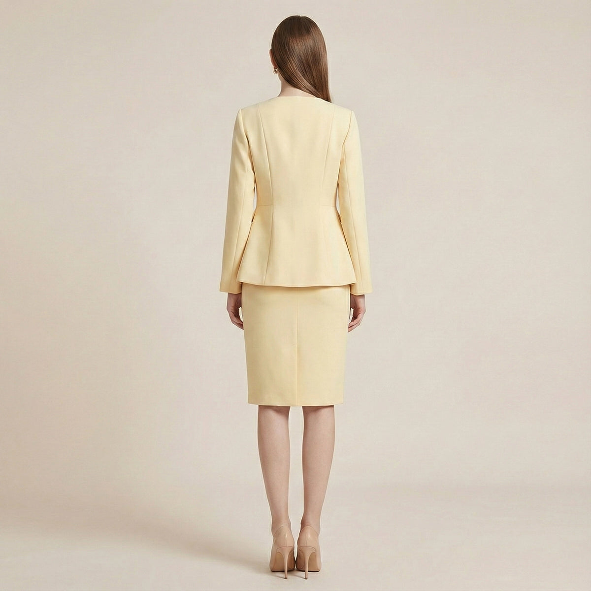 Woman wearing a light yellow suit on a beige background