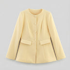 Light yellow jacket with button details on a light gray background