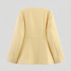 Light yellow blazer on a light gray background