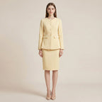 Woman wearing a light yellow suit on a beige background