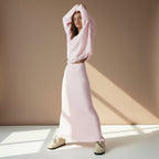 Woman wearing a pink outfit on a plain background