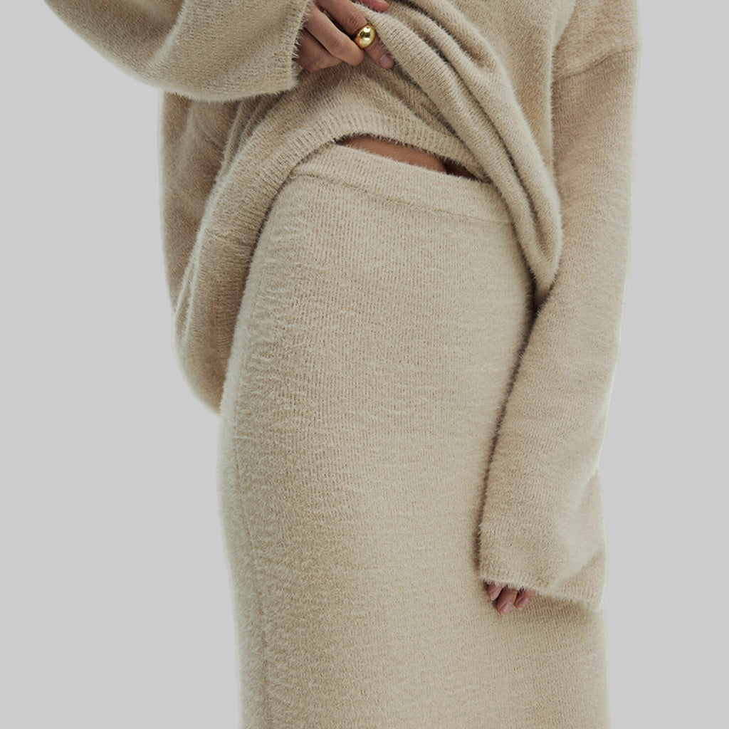 Beige knit outfit with a white background