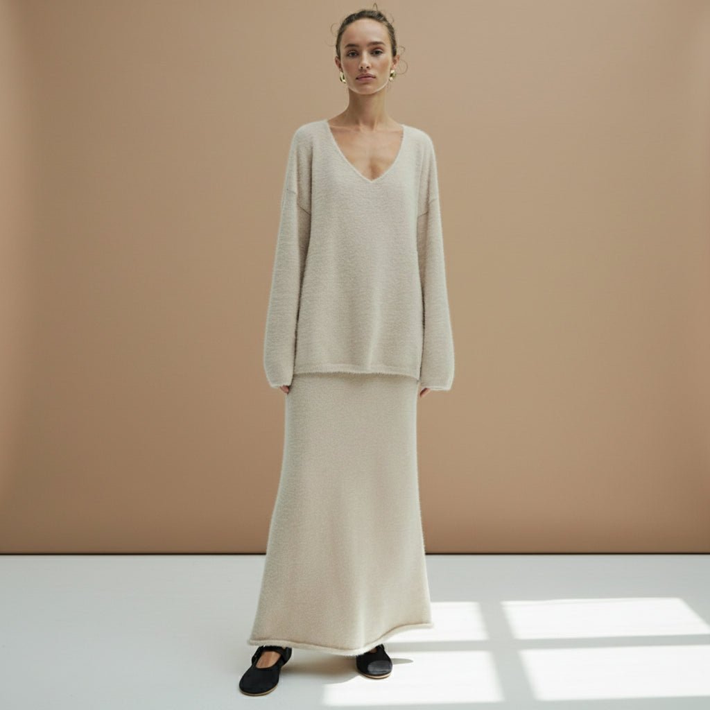 Woman wearing a beige outfit on a plain background