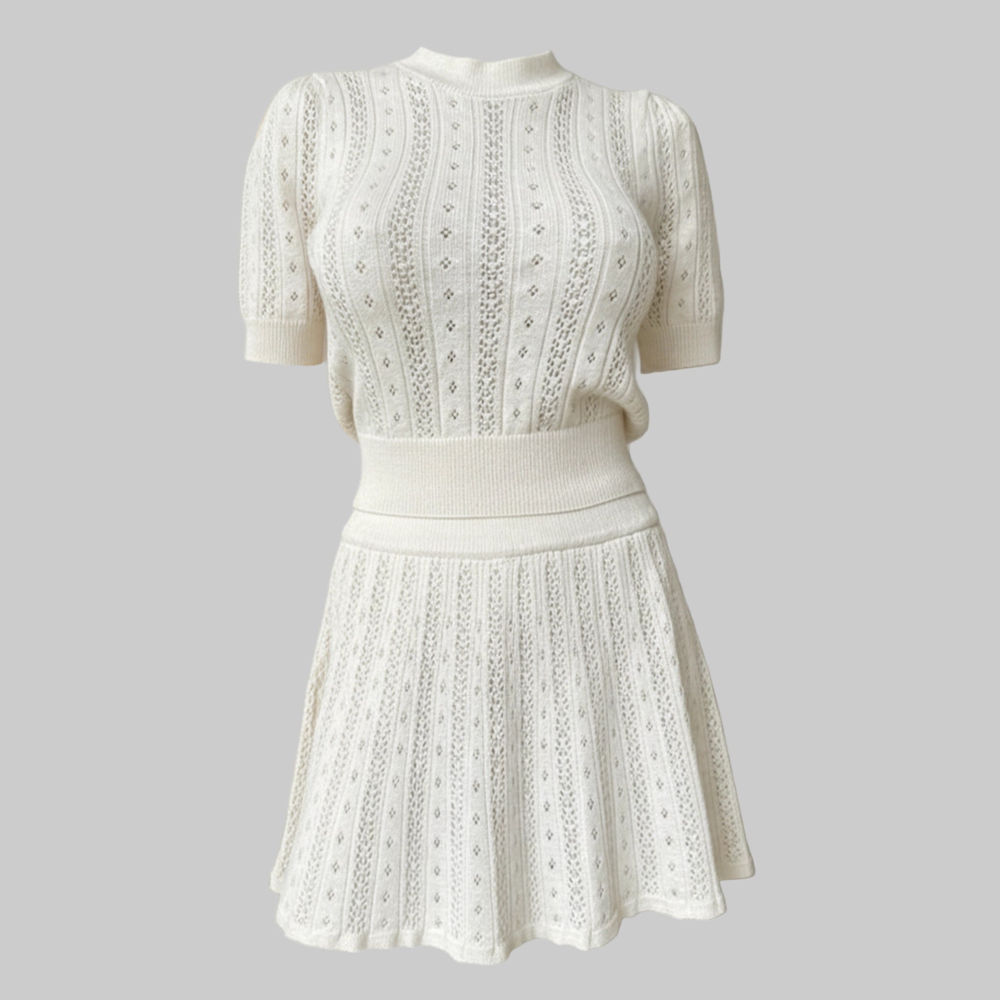 White lace dress on a mannequin against a neutral background
