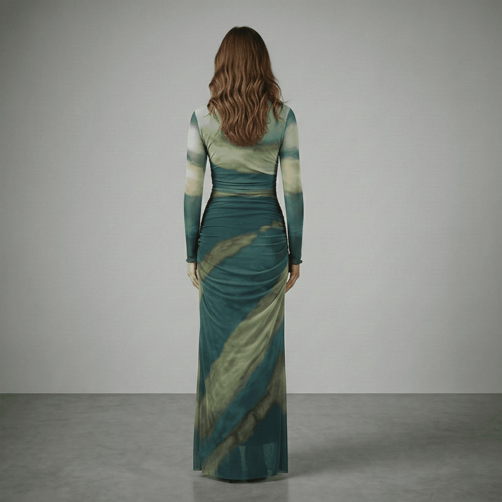 Woman wearing a green and blue patterned dress against a gray background