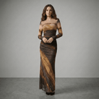 Woman wearing a long, patterned dress against a gray background