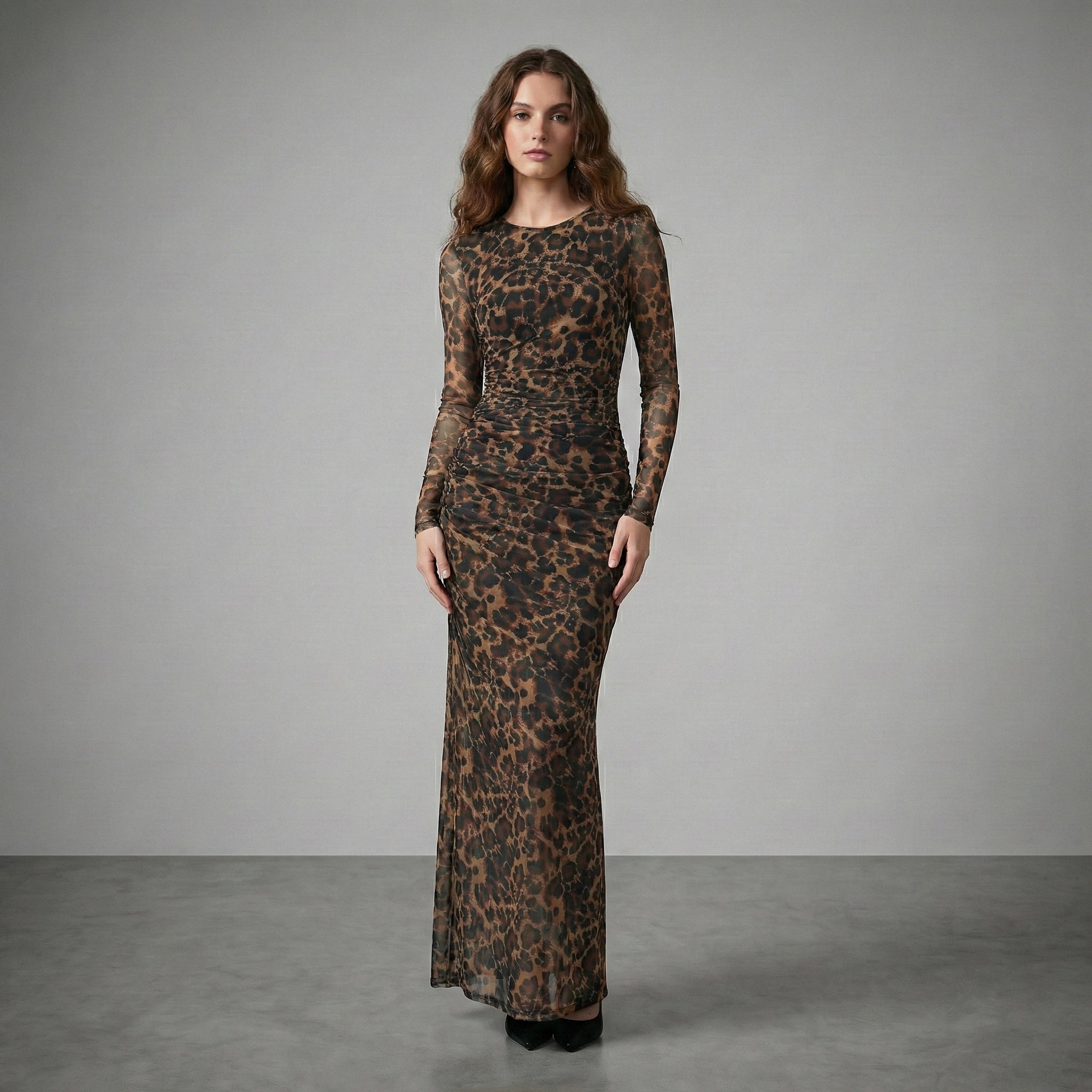 Woman wearing a leopard print dress against a gray background