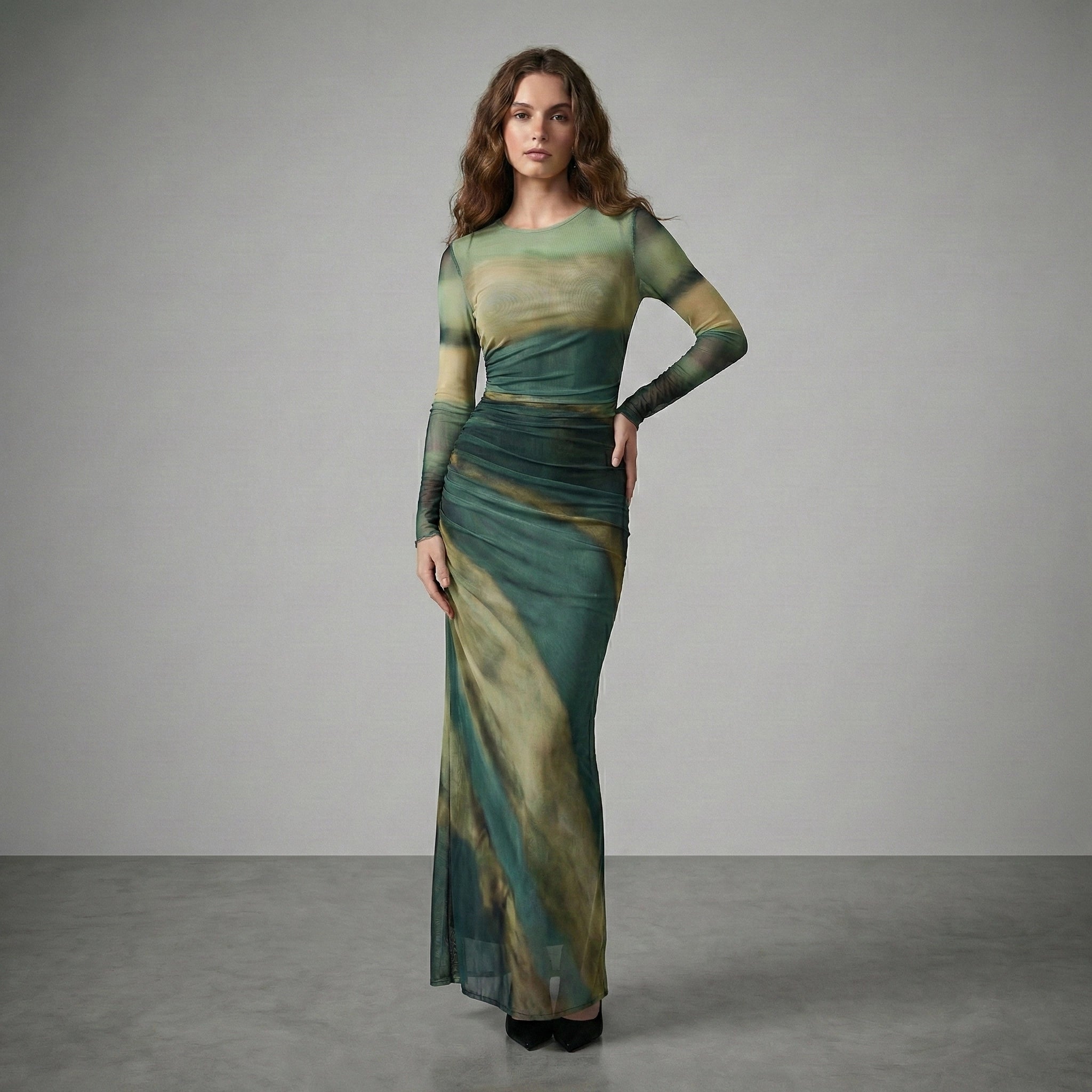 Woman wearing a green and beige dress against a gray background