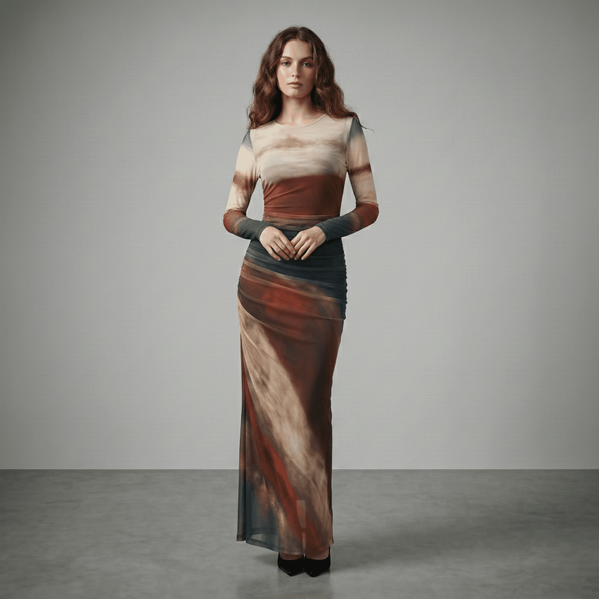 Woman wearing a long, multicolored dress against a gray background