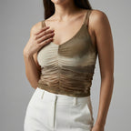 Woman wearing a beige and brown gradient tank top against a gray background