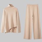 Beige sweater and pants set on a white background