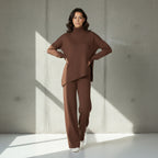 Woman wearing a brown outfit on a gray background