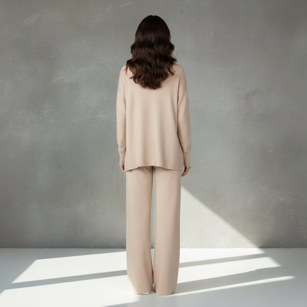 Woman wearing a beige suit on a light gray background