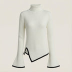 White ribbed sweater with black trim on a light beige background