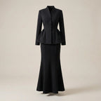 Black suit with peplum top on a beige background