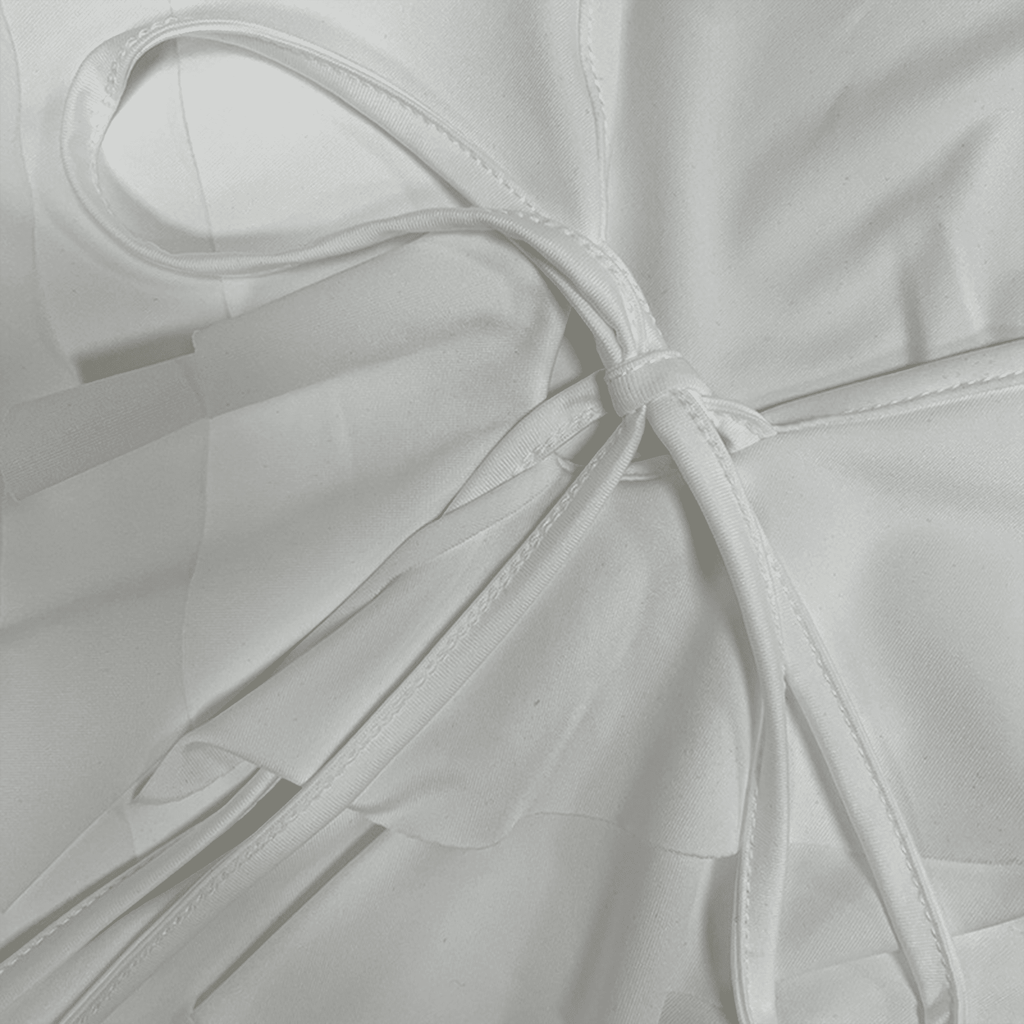 Close-up of a white fabric with a bow detail