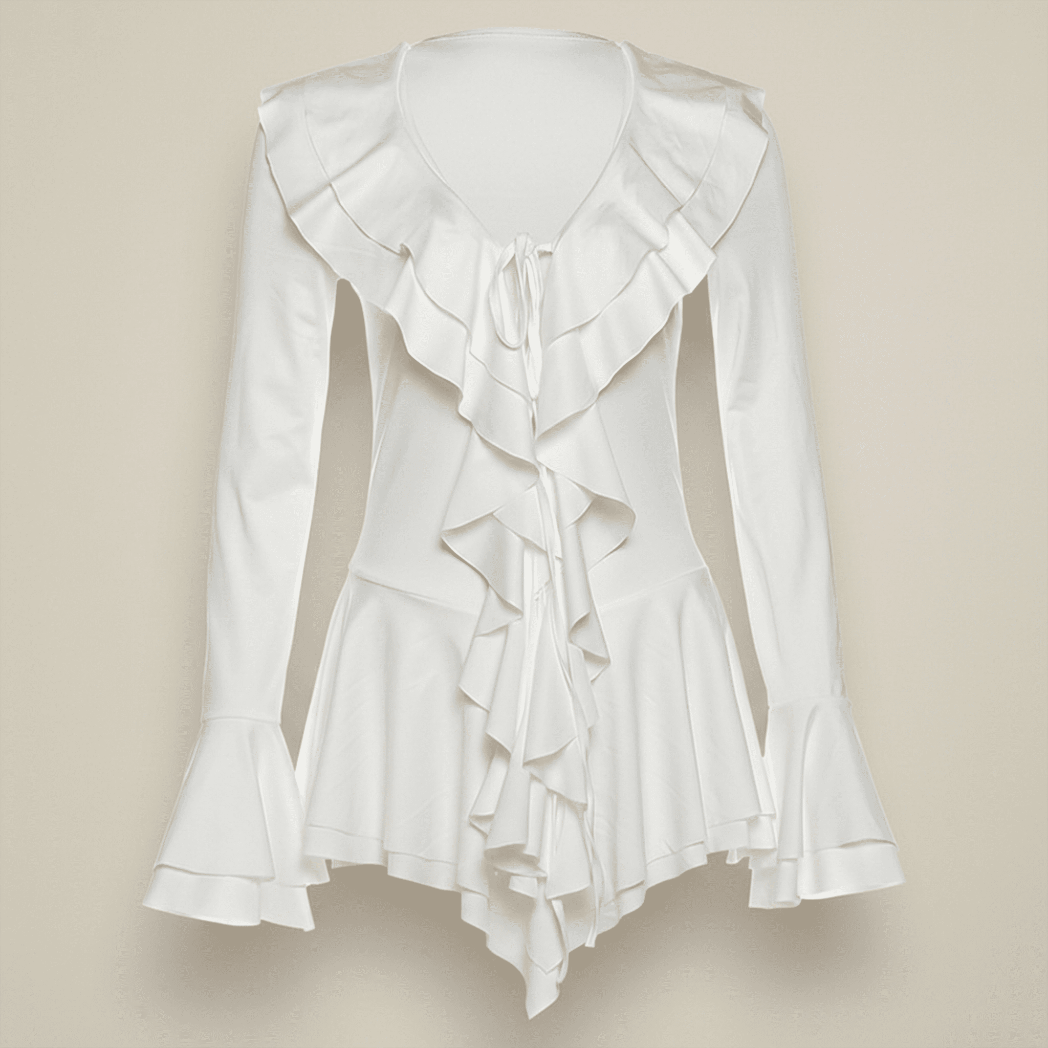 White ruffled blouse on a beige background